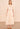 The Ulla Johnson Dani Dress is finished with scallop-edged eyelets and stripe embroidery for texture. Split neck silhouette belts at the waist and falls into a pleated drop skirt.